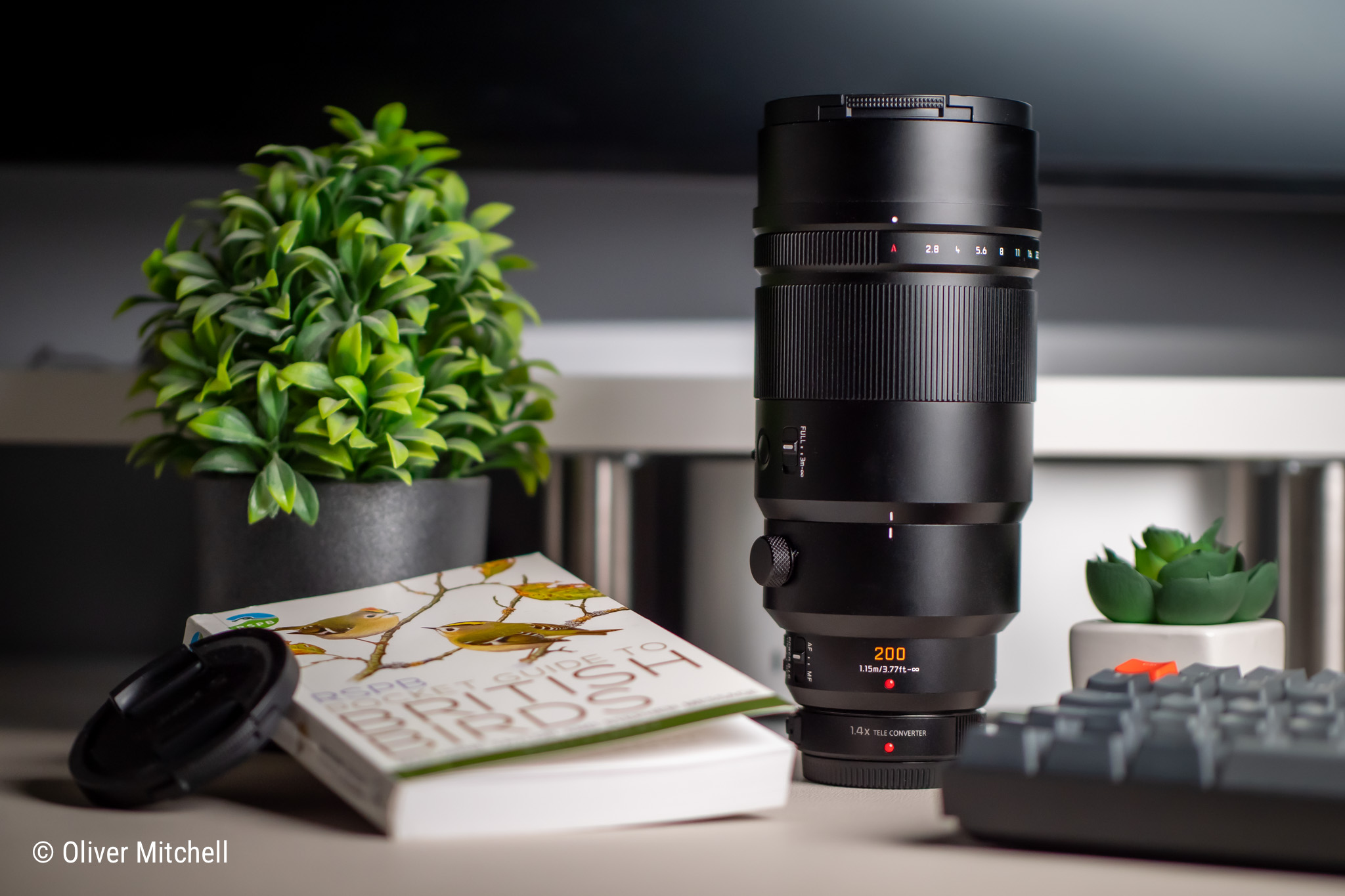 Panasonic Leica DG Elmarit 200mm f/2.8 on a desk